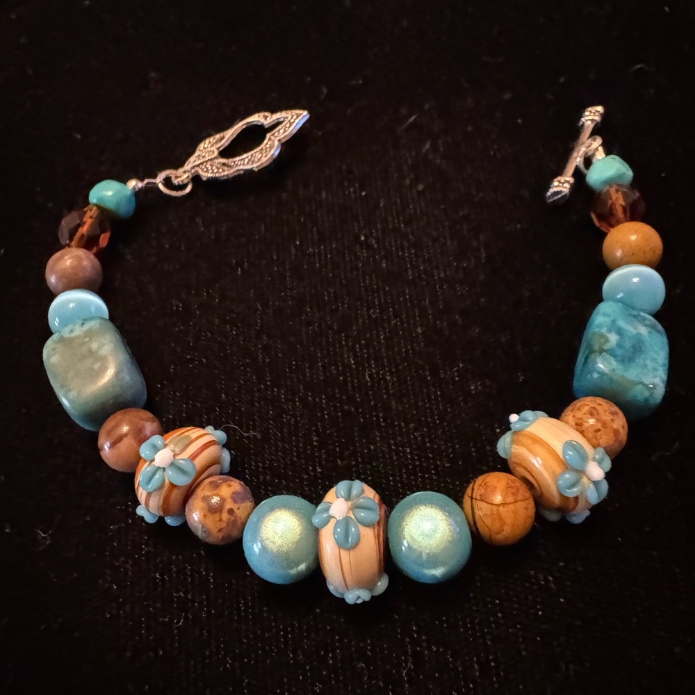 Artisan crafted imported Canadian handblown glass beads, blue mermaid accents.